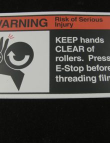 30018538 - LABEL REGULATORY ANSI WARNING 'KEEP AWAY FROM ROLLERS' (SIZE = 6.63 X 3.64)